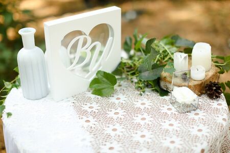White little box for wedding rings on handmade altar with candles. Concept of bridal decorations and components.の写真素材