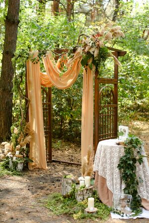 Amazing decorated wedding altar in green garden. Concept of marriage ceremony place and photo session in open air.の写真素材