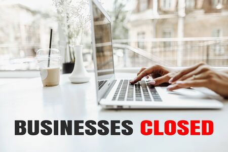 Female hands texting on laptop keyboard at home because of quarantine. Concept of closed business.の写真素材