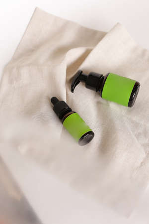 Bottle glass container and pipette dropper with cosmetic products and green space for your brand. Concept of cluelty free, organic, kosher cosmetic is great for dry and rough skin.の写真素材