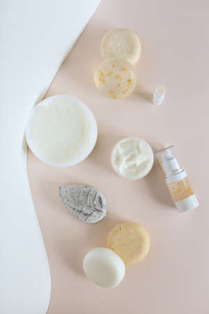 Top view of natural eco cosmetic products, organic soaps and spray bottle in light pink background. Concept of handmade non gmo cosmetics.の写真素材