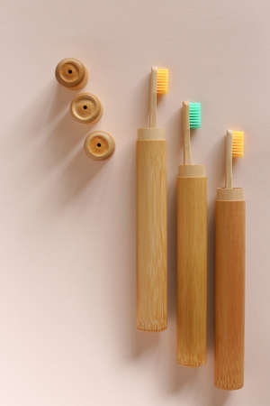 A family set of three ecological wooden toothbrushes on isolated background. Concept of hygiene and eco friendly products.の写真素材