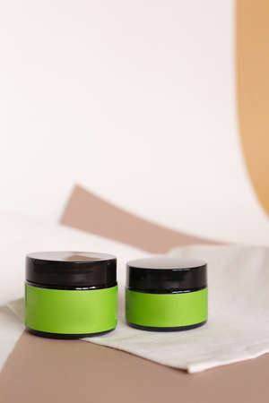 Focus on two jars of facial cosmetic cream with green space for brand. Concept of cluelty free,...