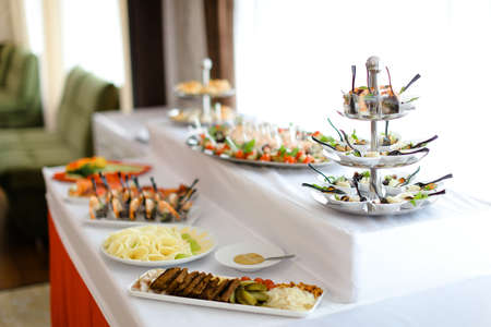 Yummy meals on table with white tablecloth. Concept of food for wedding banquet.の写真素材