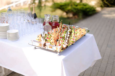 Delicious expensive meals on table with white tablecloth outside. Concept of food and outdoor...