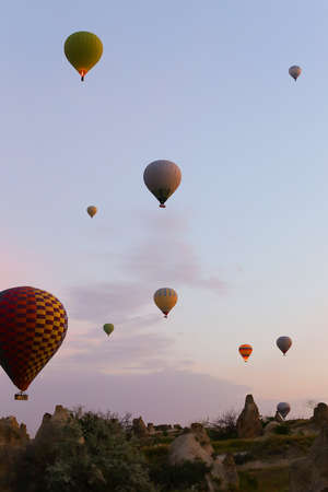 Hot colorful air ballons flying over Cappadocia. Concept of trip to Turkey, turkish vacations.の写真素材
