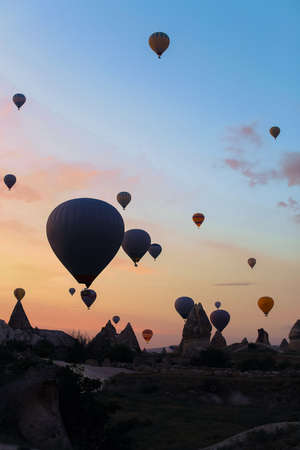 Colorful hot air ballons flying over Cappadocia. Concept of trip to Turkey, turkish vacations.の写真素材