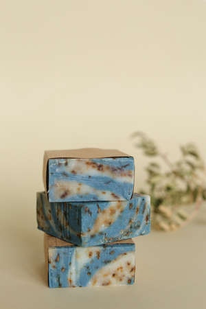 Three blue handmade floral organic soaps with essential oils on background with copy space. Concept of natural ecofriendly cosetics and non gmo products for skincare and healthy lifestyle.の写真素材