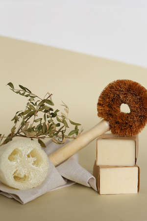 Classic wooden dish brush near eco handmade soaps, loofah sponge with copy space. Concept of reducing of plactic dishbrushes and ecological products in online shop.の写真素材