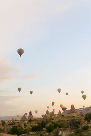 Amazing hot air balloons flying over Cappadocia rocks. Concept of vacations in Turkey and turkish festival.の写真素材