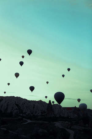 Wonderful hot air balloons flying over Cappadocia rocks. Concept of vacations in Turkey and turkish festival.の写真素材