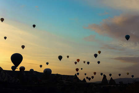 Many amazing hot air balloons flying over Cappadocia rocks. Concept of vacations in Turkey and turkish festival.の写真素材
