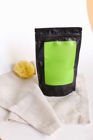 Close up black doy pack with cosmetic product and green space for your brand. Concept of cluelty free, organic, kosher cream is great for dry and rough skin.の写真素材
