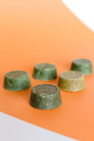 Four bars of natural homemade ultra moisturising green soap on orange background. Concept of skincare, non gmo cosmetics organic online shop.の写真素材