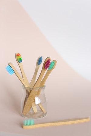 Family set of ecological new wooden toothbrushes with colorful bristle in light isolated background. Concept of eco friendly products shop and teeth hygiene.の写真素材