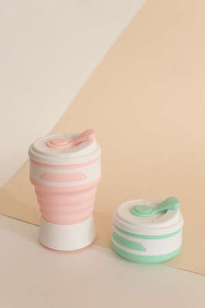 Silicone reusable bottles for water or drinks in light background with copy space. Concept of reducing plastic, ecofriendly products.の写真素材