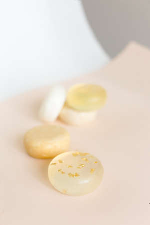 Five bars of organic handmade translucent soap in light background.の写真素材