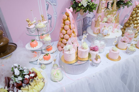 Many sweet cakes and candies on wedding table.の写真素材