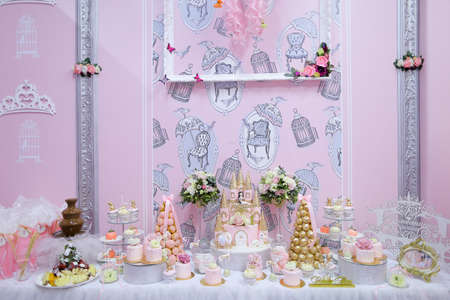 Many delightful sweet cakes and candies on wedding table.の写真素材