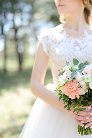 Focus on bouquet of flowers in bride hands.の写真素材