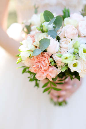 Close up nice bouquet of flowers in bride hands.の写真素材
