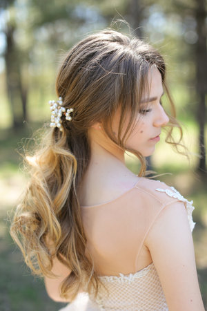 Profile portrait of caucasian bride walking in park.の写真素材