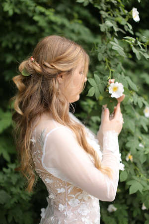 Profile portrait of bride without vail in green plant background.の写真素材