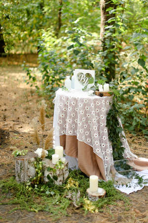 White decorated wedding table near altar outside.の写真素材