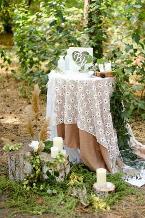 White little decorated wedding table near altar outside.の写真素材
