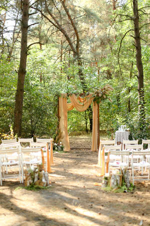 Yellow amazing wedding altar and white chairs in garden.の写真素材