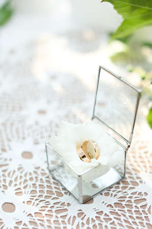 Wedding rings on white rose in little box.の写真素材