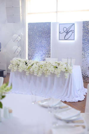 Wedding banquet table decorated by flowers.の写真素材