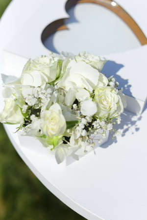 Close up bridal bouquet of flowers near shape of heart.の写真素材