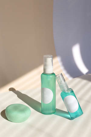 Cleansing natural cosmetics - face wash cleansing gel, smoothing toner, striped shadow background.の写真素材