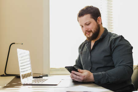 Successfel businessman working with laptop and smartphone at ofice.の写真素材