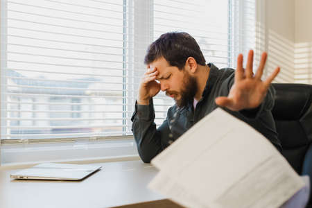 Male businessman throwing documents at office.