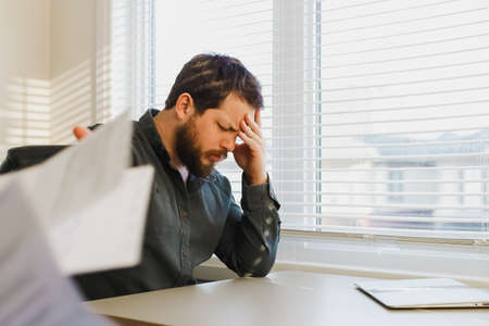 Male tired manager throwing documents at office.の写真素材