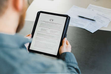 Businessman review electronic cv on tablet.の写真素材