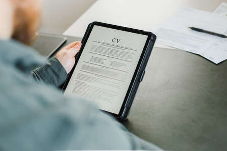 Bearded businessman review electronic cv on tablet.の写真素材