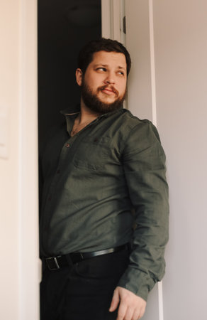 Portrait of smart european man standing at office and wearing shirt.の写真素材
