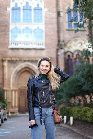 Young caucasian girl standing near old building in Europe.の写真素材