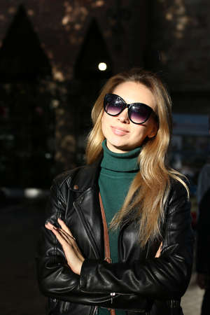 Portrait of caucasian pretty girl in sunglasses and leather jacket.の写真素材