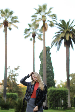 Blonde caucasian girl standing near palms.の写真素材