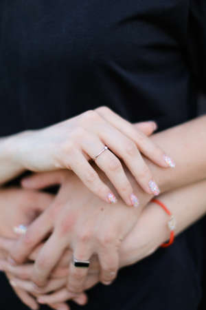 Male and female arms with ring holding each other.の写真素材