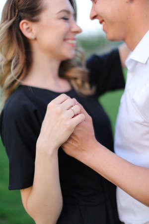 Focus on ring and arms, happy boy and girl holding hands.の写真素材