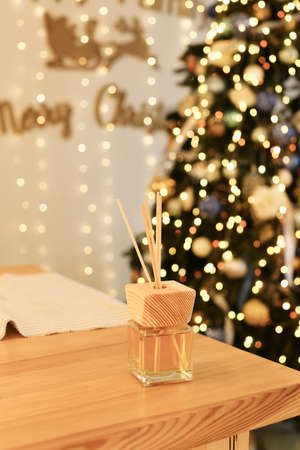 Aromatherapy reed diffuser air freshener on relaxed christmas backgroundの写真素材