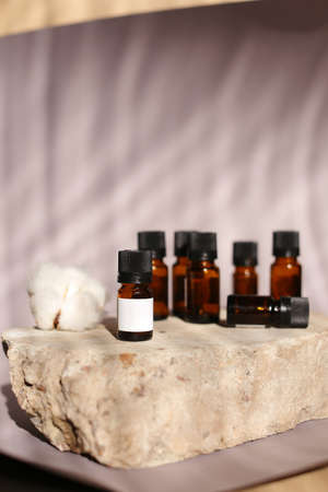 different cosmetics products on rock, Essential oils or face toner samplesの写真素材