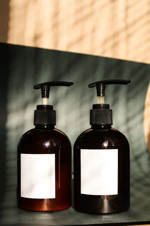 Eco friendly Bottle or jar with natural skincare cosmetics, creams or oils on green background. Plant-based beauty productsの写真素材