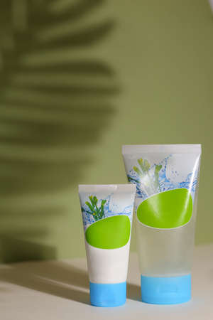 Eco friendly tubes with natural skincare cosmetics, creams or oils on light background. Plant-based beauty productsの写真素材