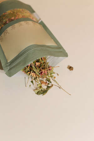 Herbal tea in package on neutral light background with copy space for your textの写真素材